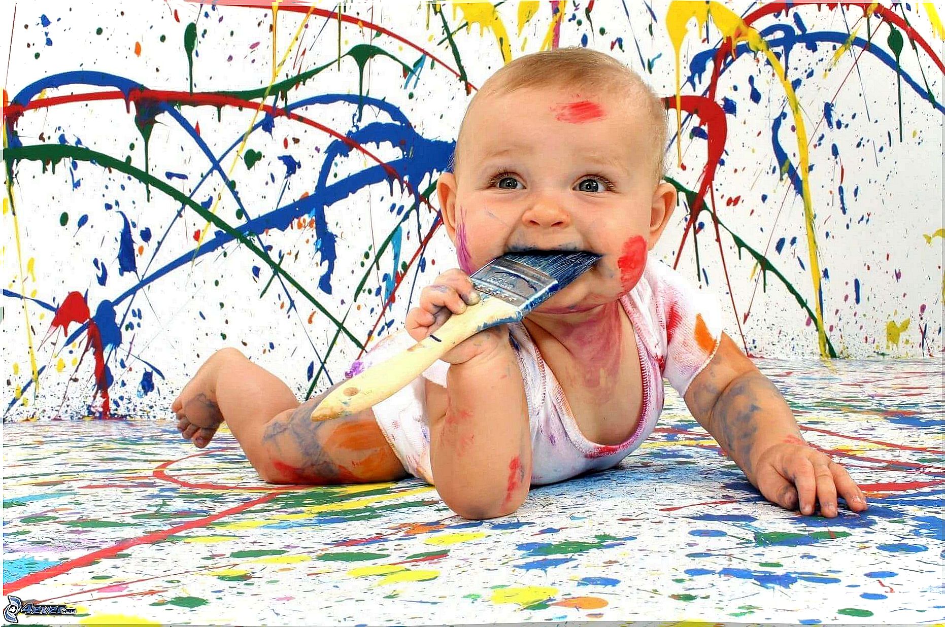 Baby playing with paint.