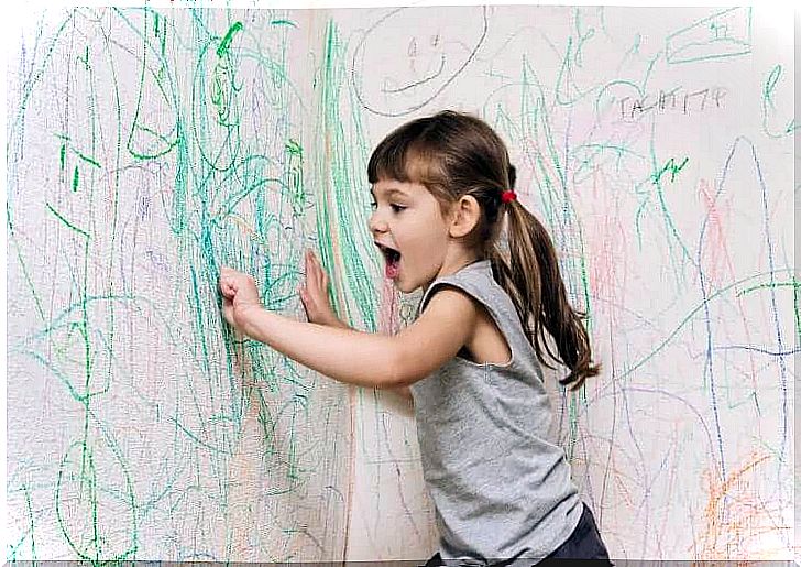 Girl doodling walls.